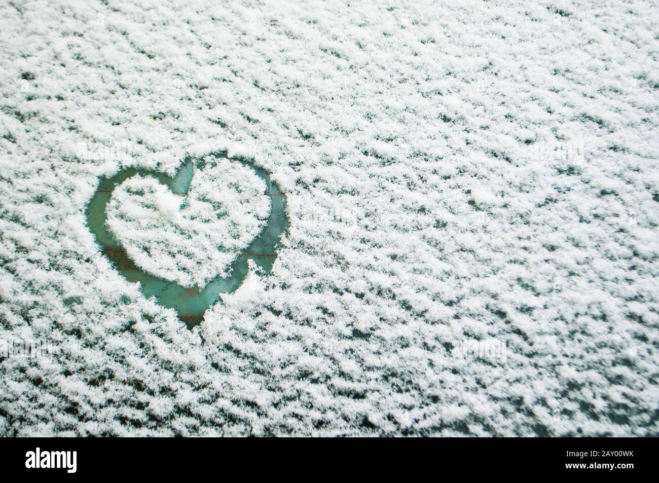 Symbol of heart on the background of fresh snow texture with copyspace ...