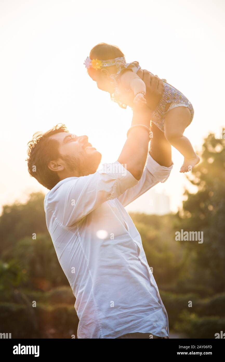 Image of cute little daughter in young dad's hands. Father and ...
