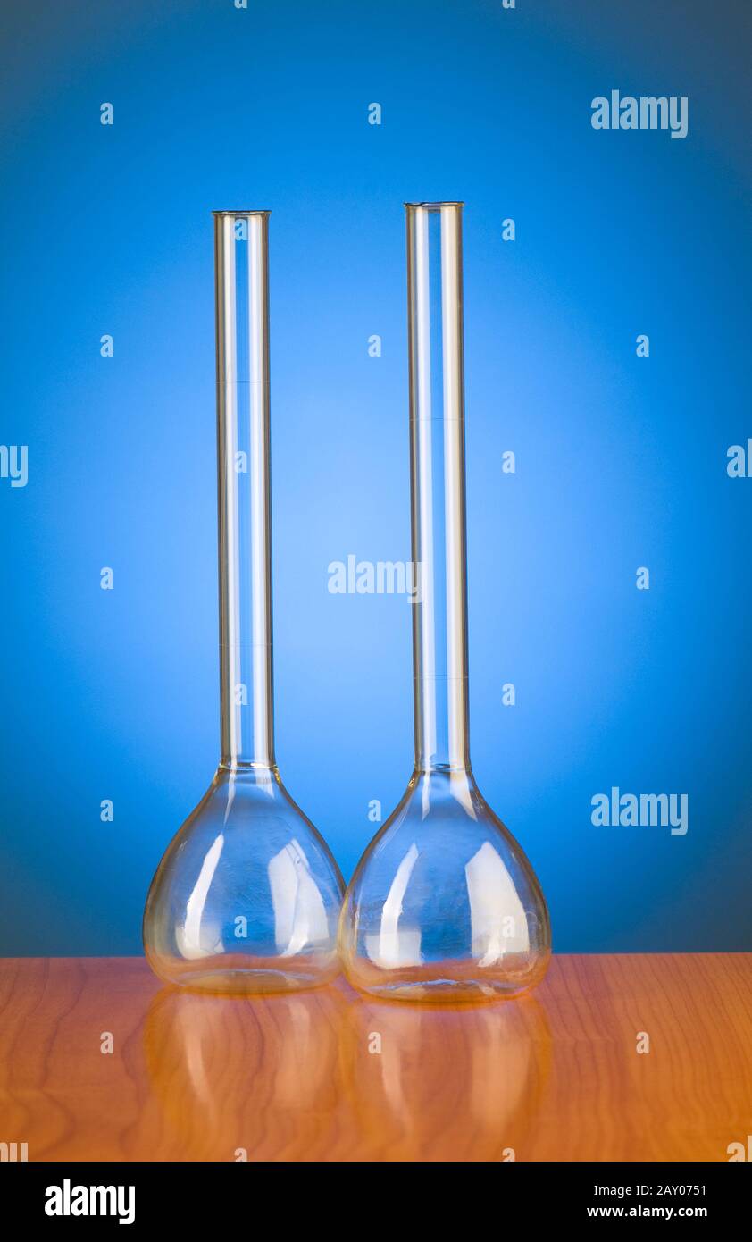 Glass retorts against blue gradient background Stock Photo Alamy