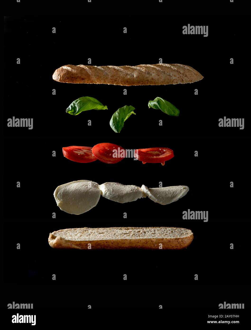 levitating ingredients of a tasty veggie sandwich on black background Stock Photo