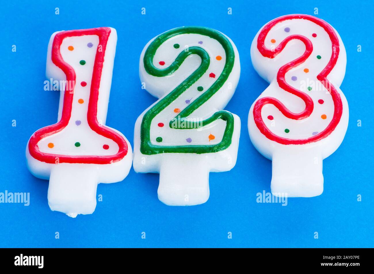 Birthday candles against colourful background Stock Photo - Alamy