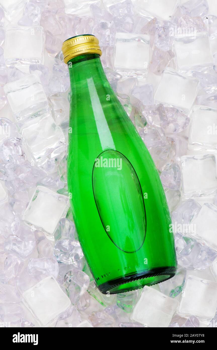 Green bottle of water on ice cubes Stock Photo - Alamy