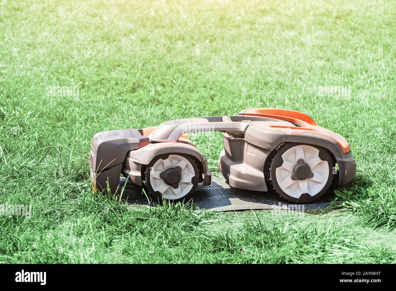 20 July 2019, Vienna, Austria: Robot automatic lawn mower working on a grass. Stock Photo