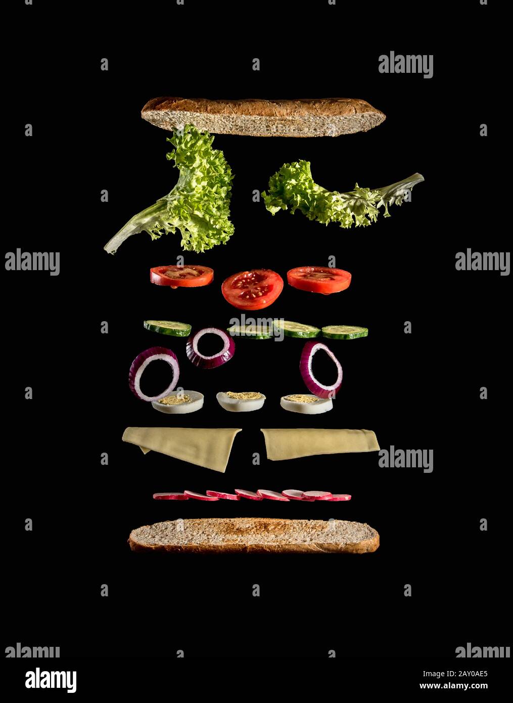 levitating ingredients of a tasty veggie sandwich on black background Stock Photo