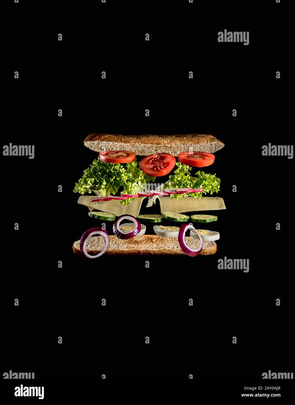 levitating ingredients of a tasty veggie sandwich on black background Stock Photo