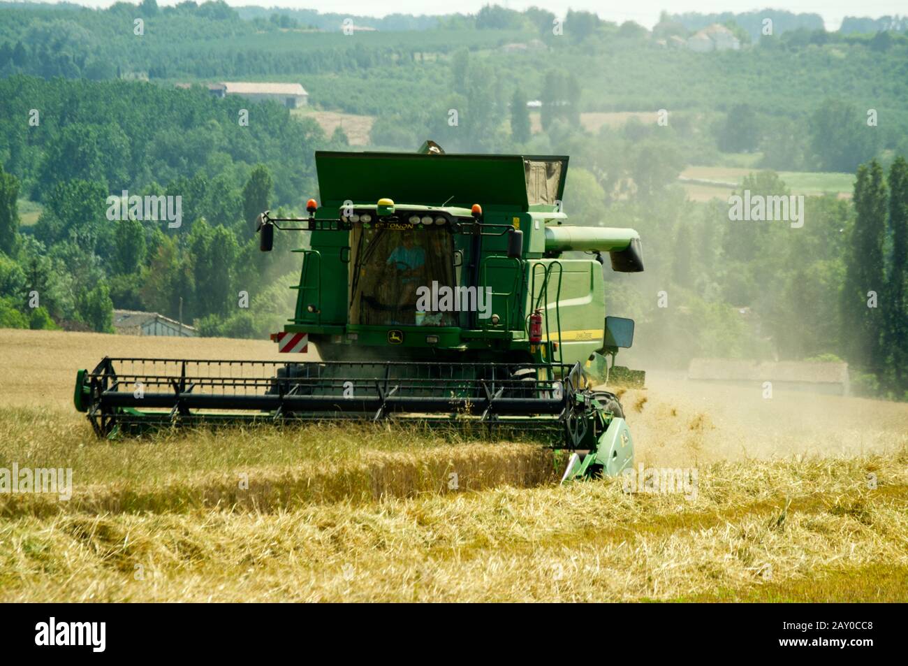 Harvesting wheat near Duras, Lot-et-Garonne, France with a John Deere T670 Hillmaster combine harvester. Stock Photo