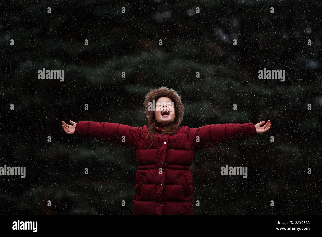 Happy girl standing outdoors in the snow, USA Stock Photo
