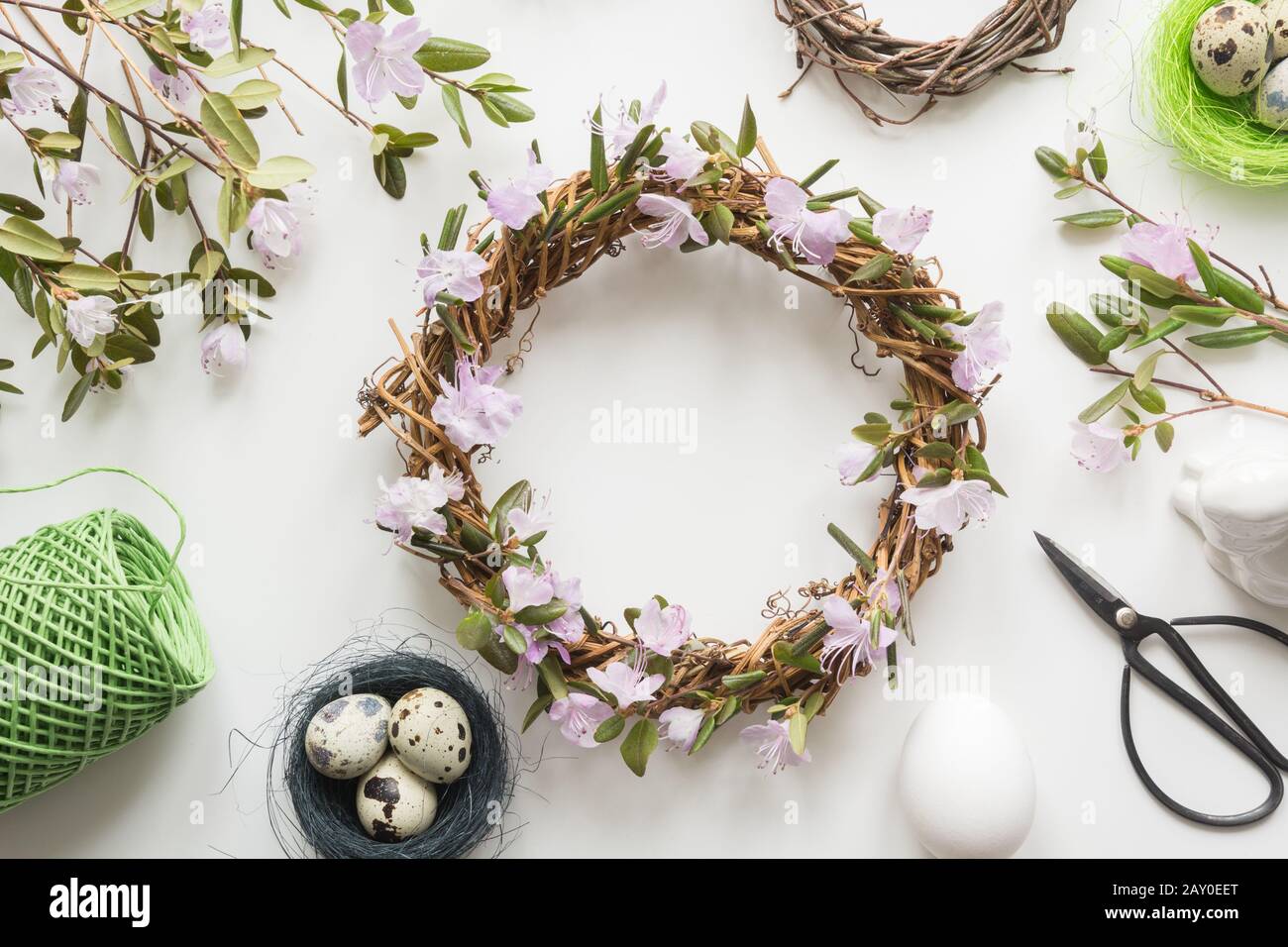 Spring wreath with flowers on light. Creative flat lay. Top view. Decor handmade. Stock Photo