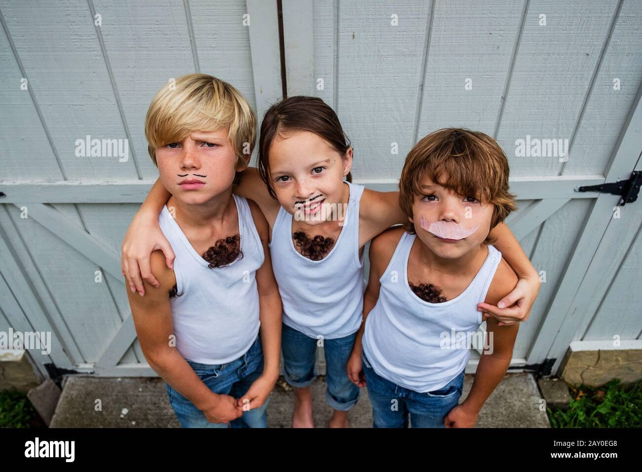 Three children dressed as musclemen, USA Stock Photo