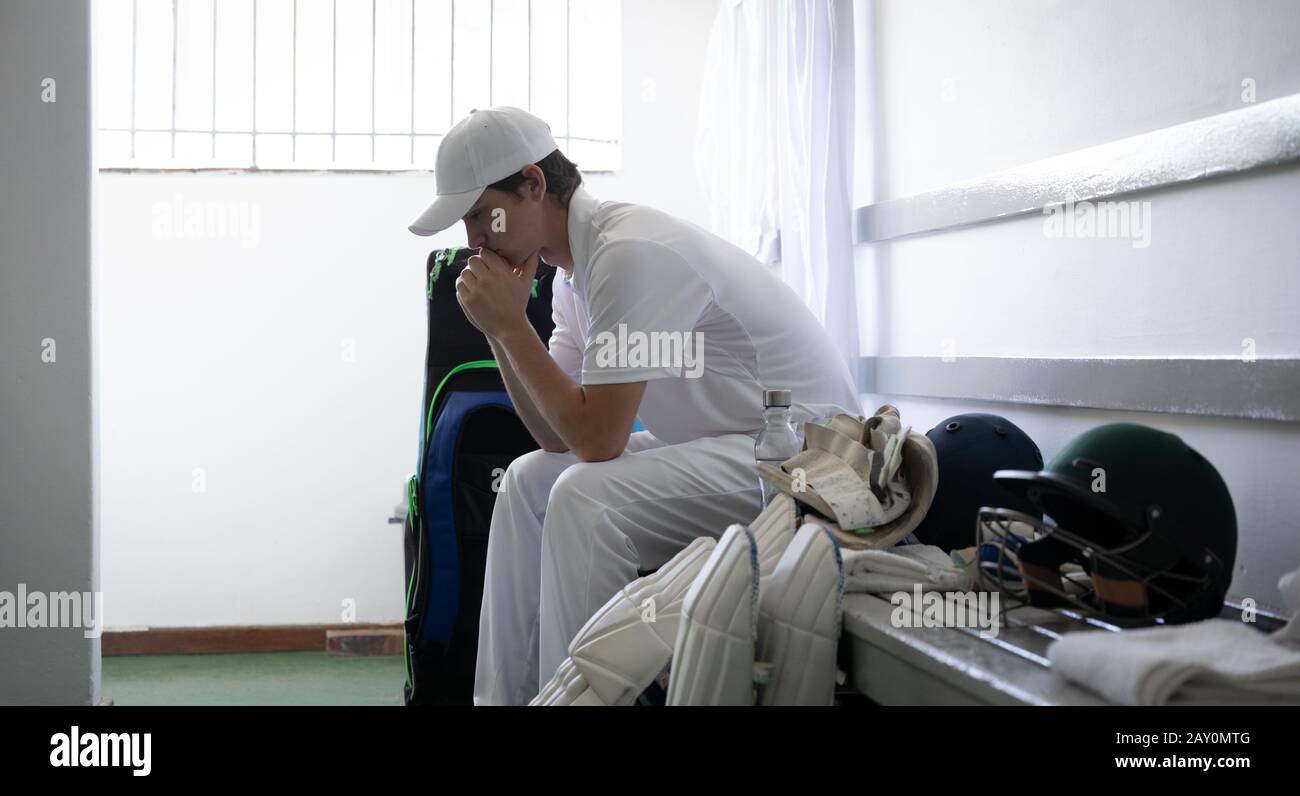 Man thoughtful before playing in the locker room Stock Photo