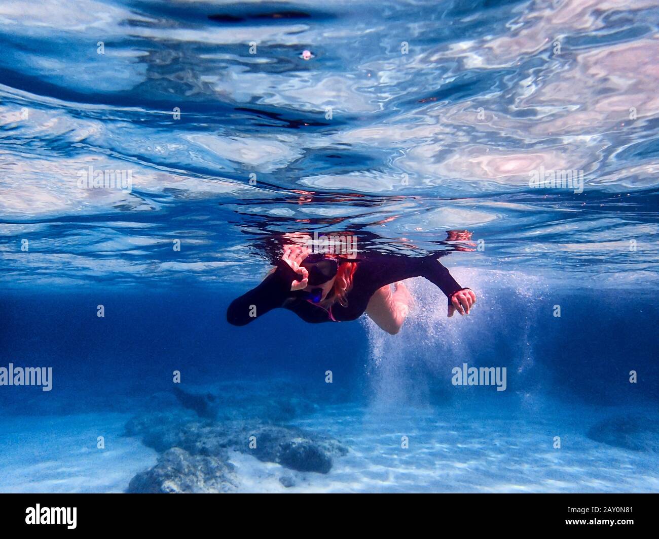 Woman snorkeling in sea making an ok sign, Greece Stock Photo