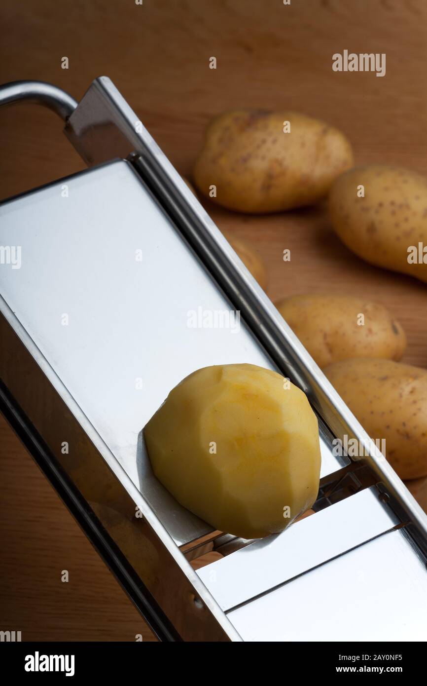 Electric Grater Cuts Raw Potatoes Stock Photo, Picture and Royalty Free  Image. Image 121450696.