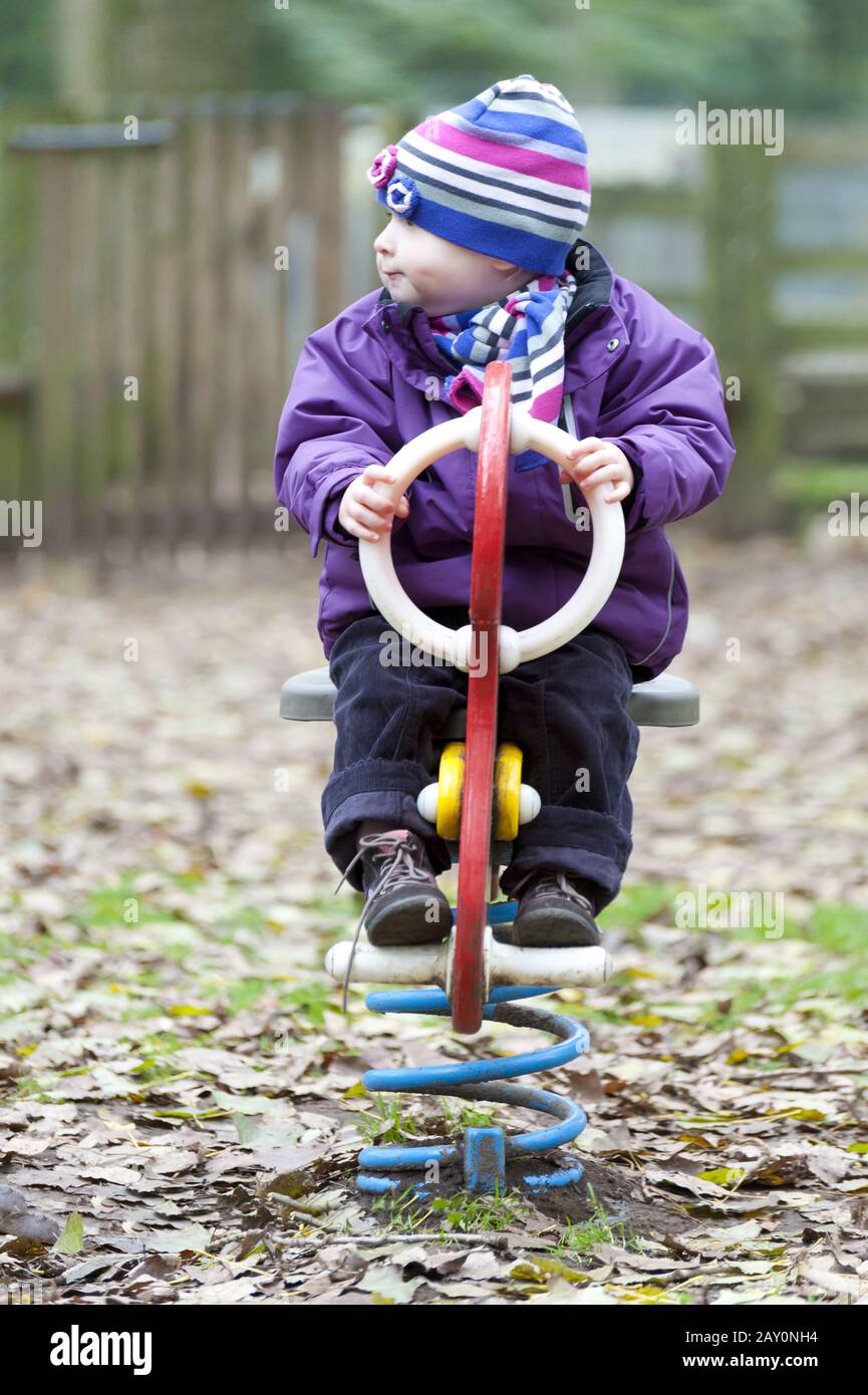 Baby girl on a seesaw Stock Photo