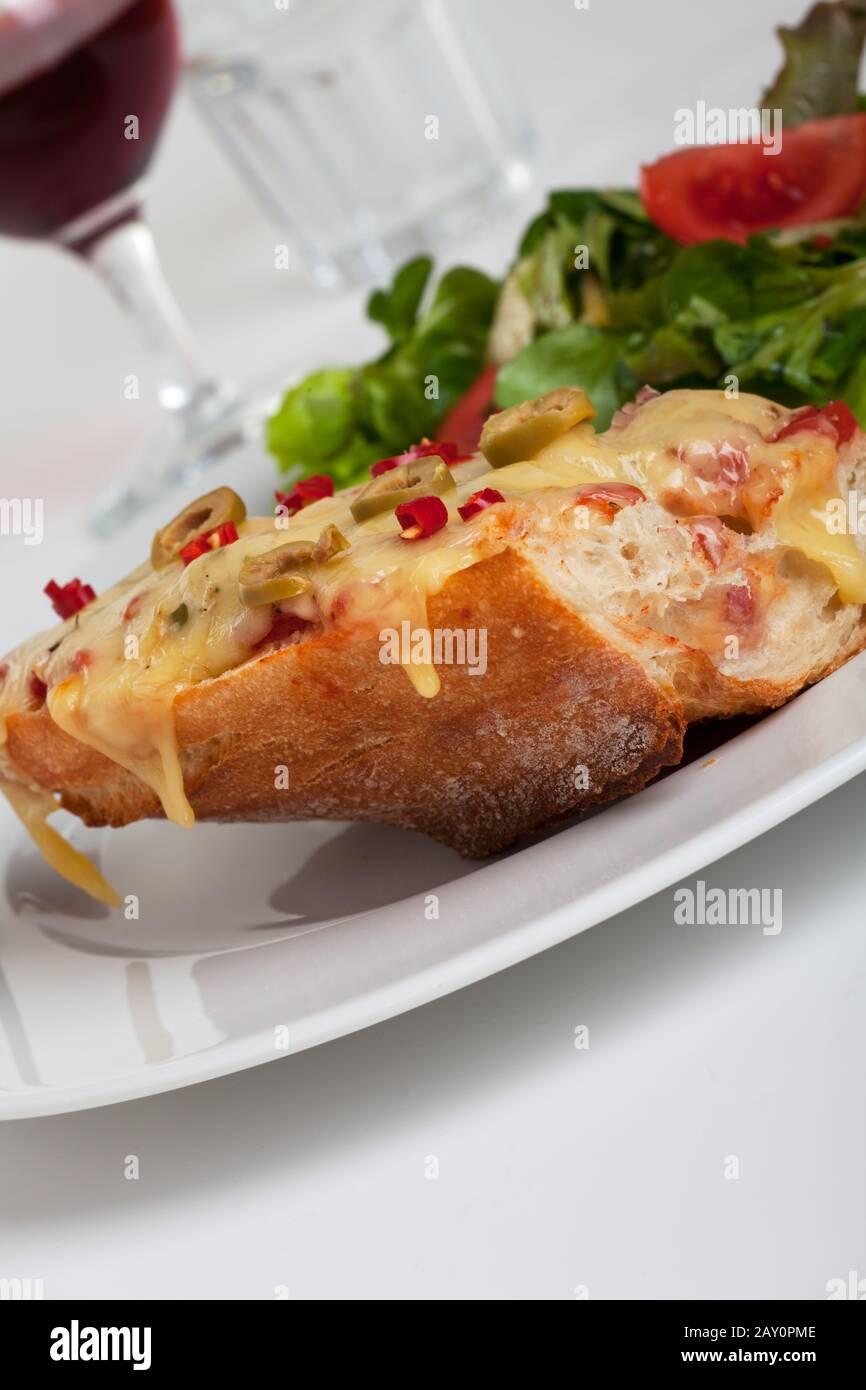 Close-up view of a baked cheese baguette Stock Photo - Alamy