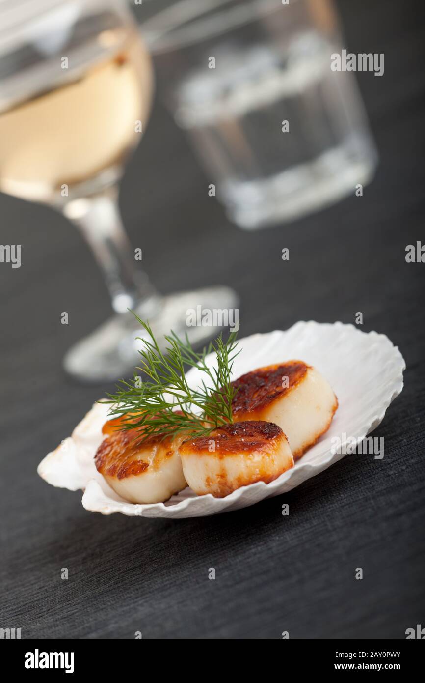 Grilled scallops with shell on a black placemat Stock Photo Alamy