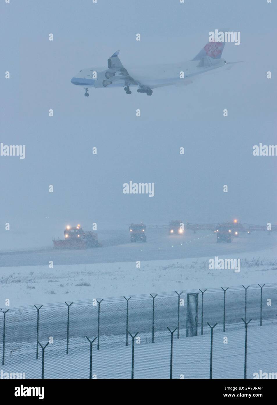 A Boeing 747 of China Airlines lands at Frankfurt Airport in heavy snow Stock Photo