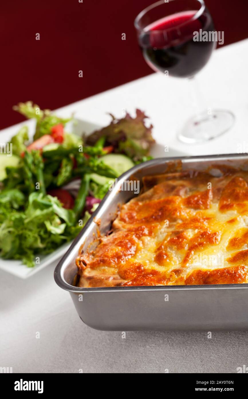 Casserole dish with lasagne and salad Stock Photo Alamy