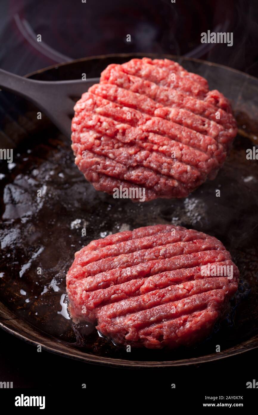 Beef patties in a pan Stock Photo Alamy