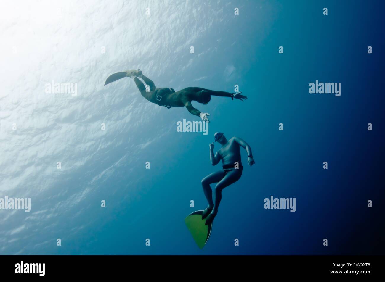 Two freedivers have fun in the depth Stock Photo