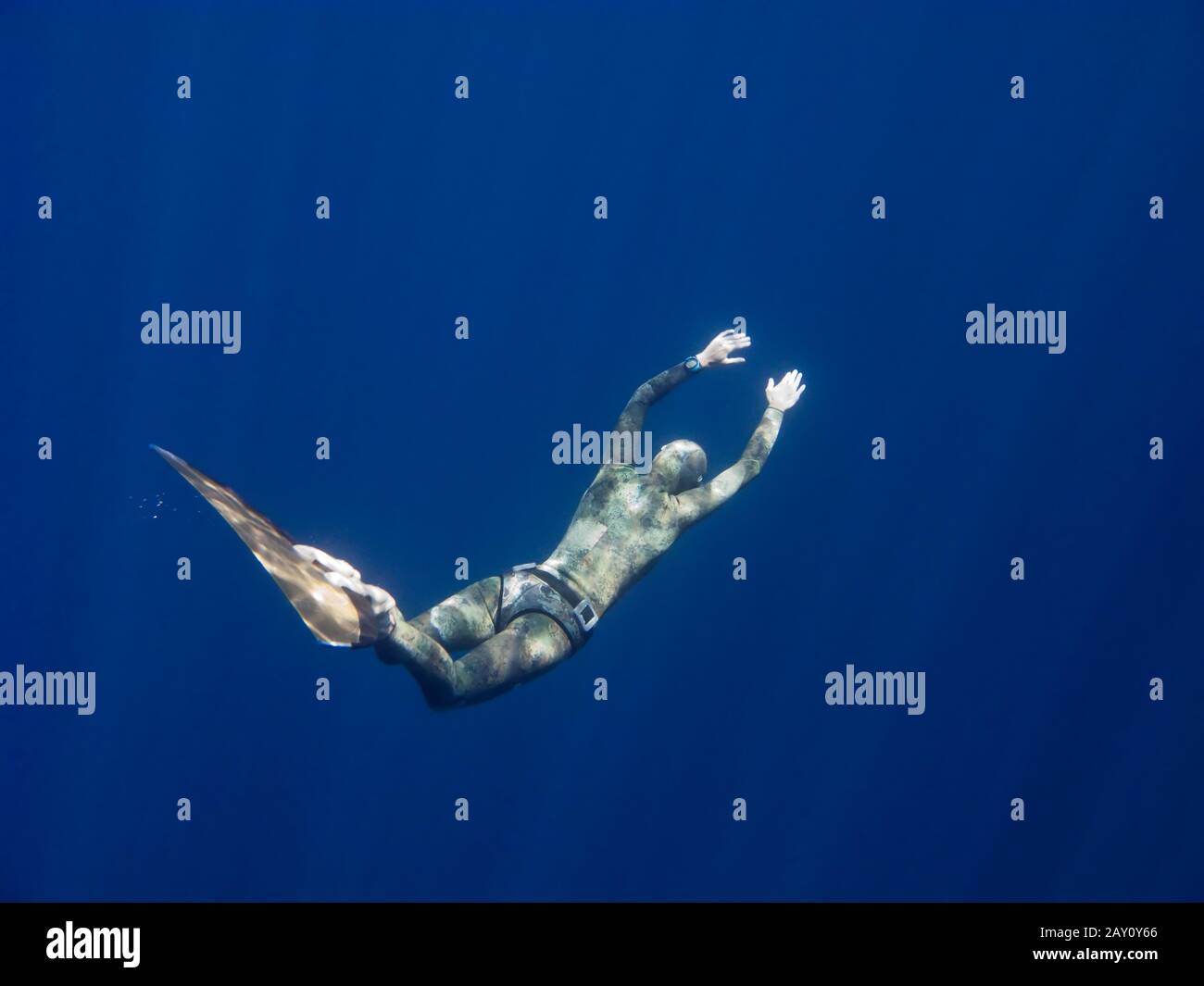 A freediver moved through the ocean depth Stock Photo