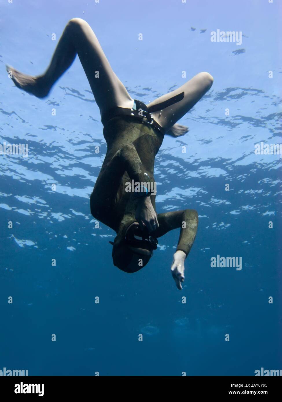 Freediver moves down from the surface of Blue Hole Stock Photo