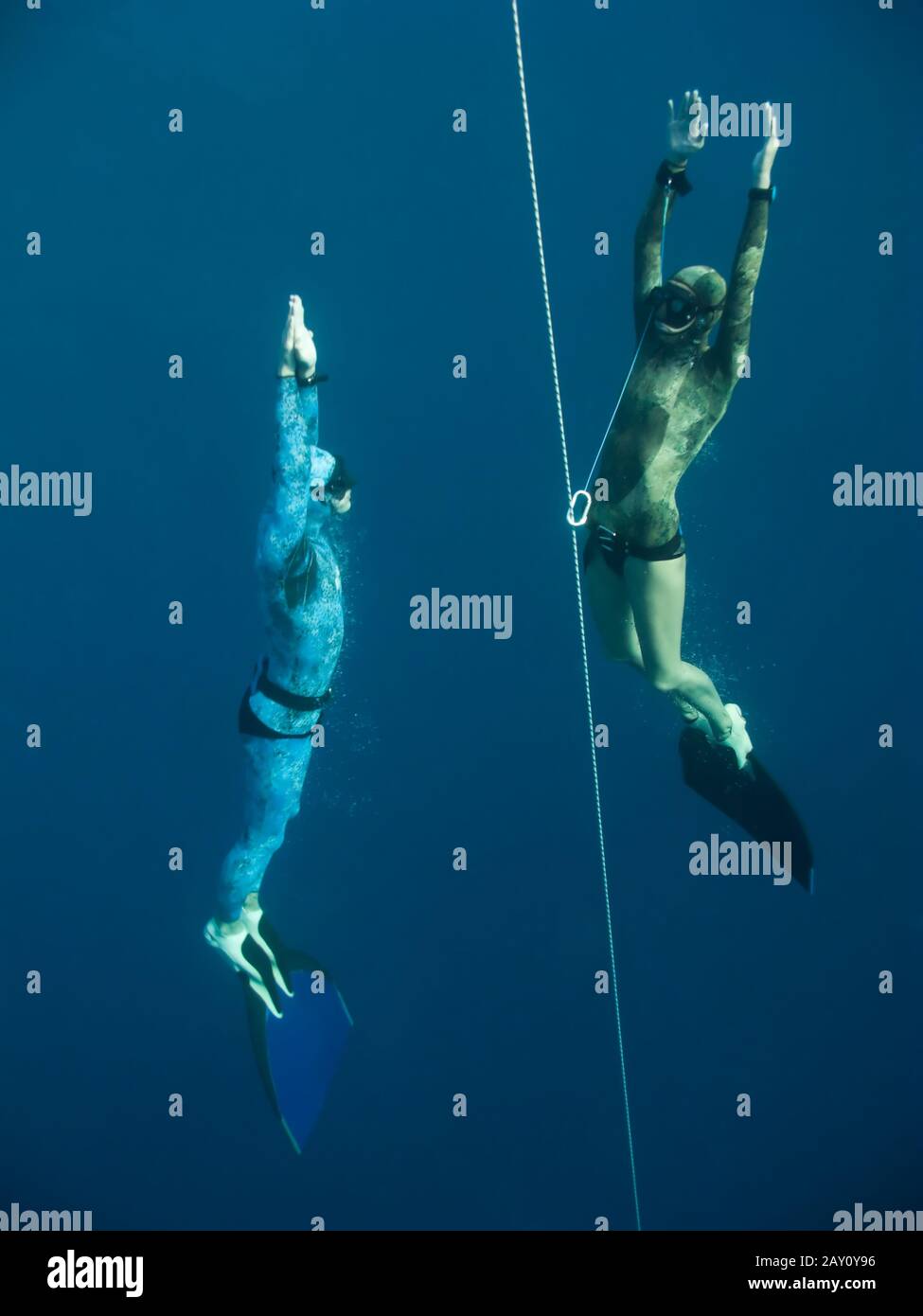 Two freedivers rise from the depth of Blue Hole Stock Photo