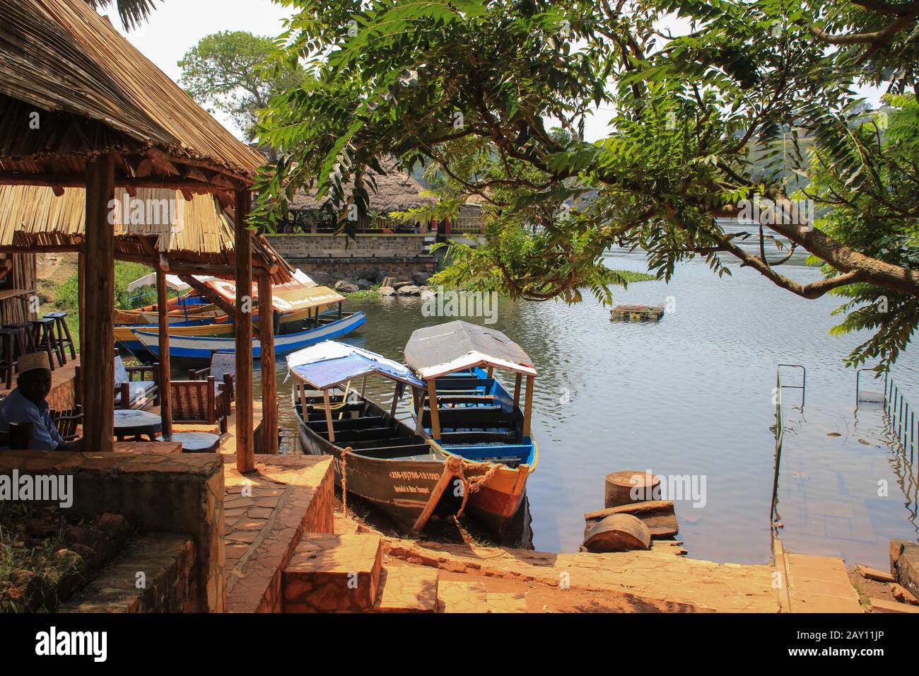 Jinja, Uganda - January 20, 2015: Restaurants and cafes with boats near the source of the Nile River. Stock Photo