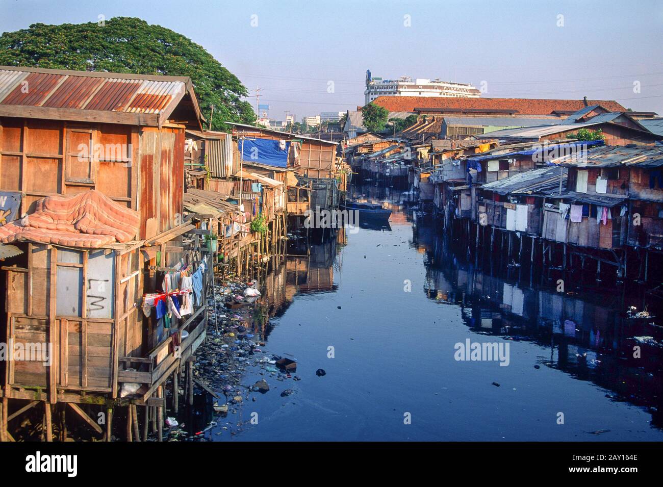 Riverside slum homes made up of shacks along a canal strewn with rubbish in Jakarta, Indonesia, June 1995 Stock Photo