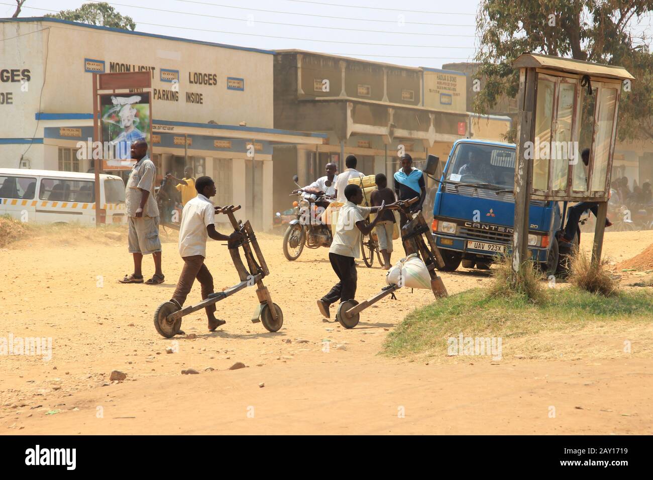 Kampala, Uganda - January 31, 2015: Home-made wooden children's scooters are used to carry goods by children in Africa. Poor African childhood and chi Stock Photo