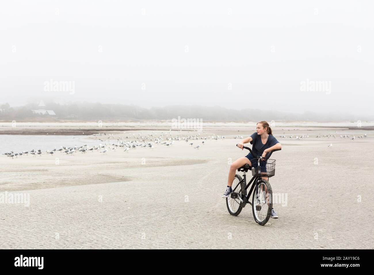 teen girl biking on sand at the beach, St. Simon's Island Stock Photo Alamy