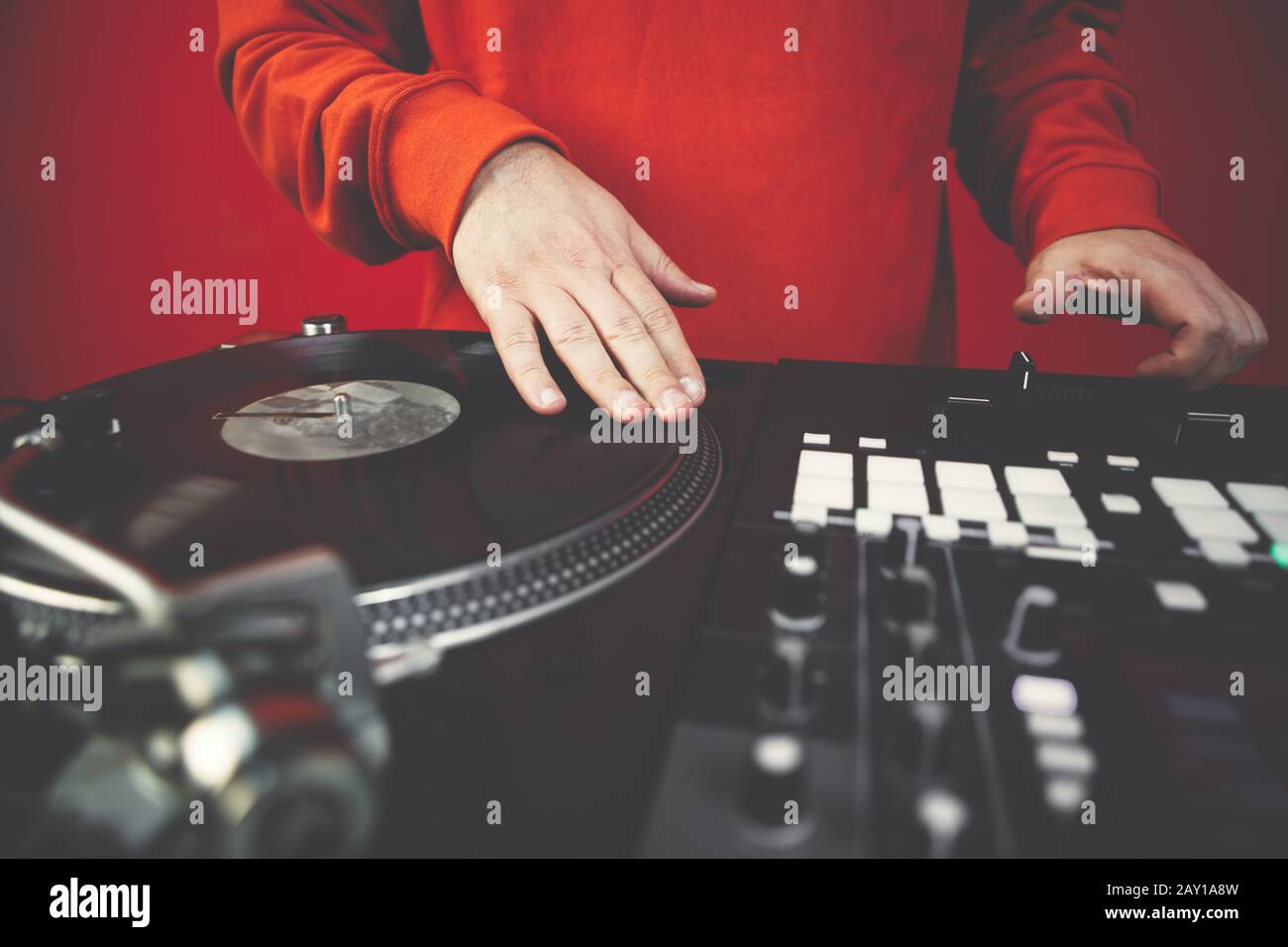 Hip hop dj scratches vinyl records on turntable player.Professional