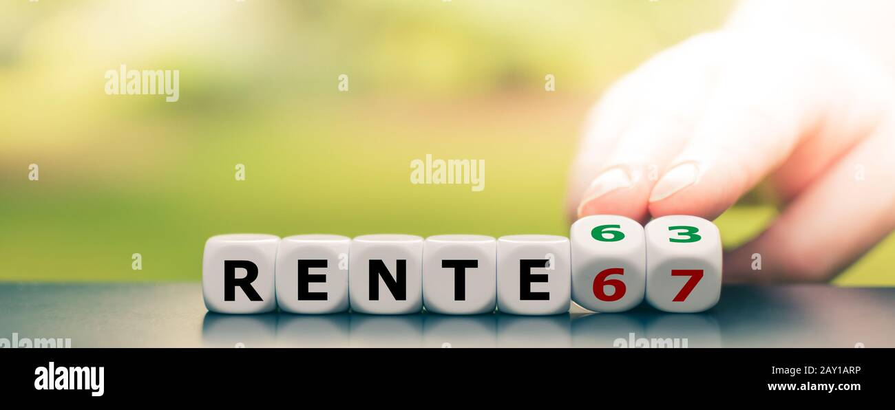 Hand turns dice and changes the German Expression 'Rente 67' ('pension 67') to 'Rente 63' ('pension 63'). Stock Photo