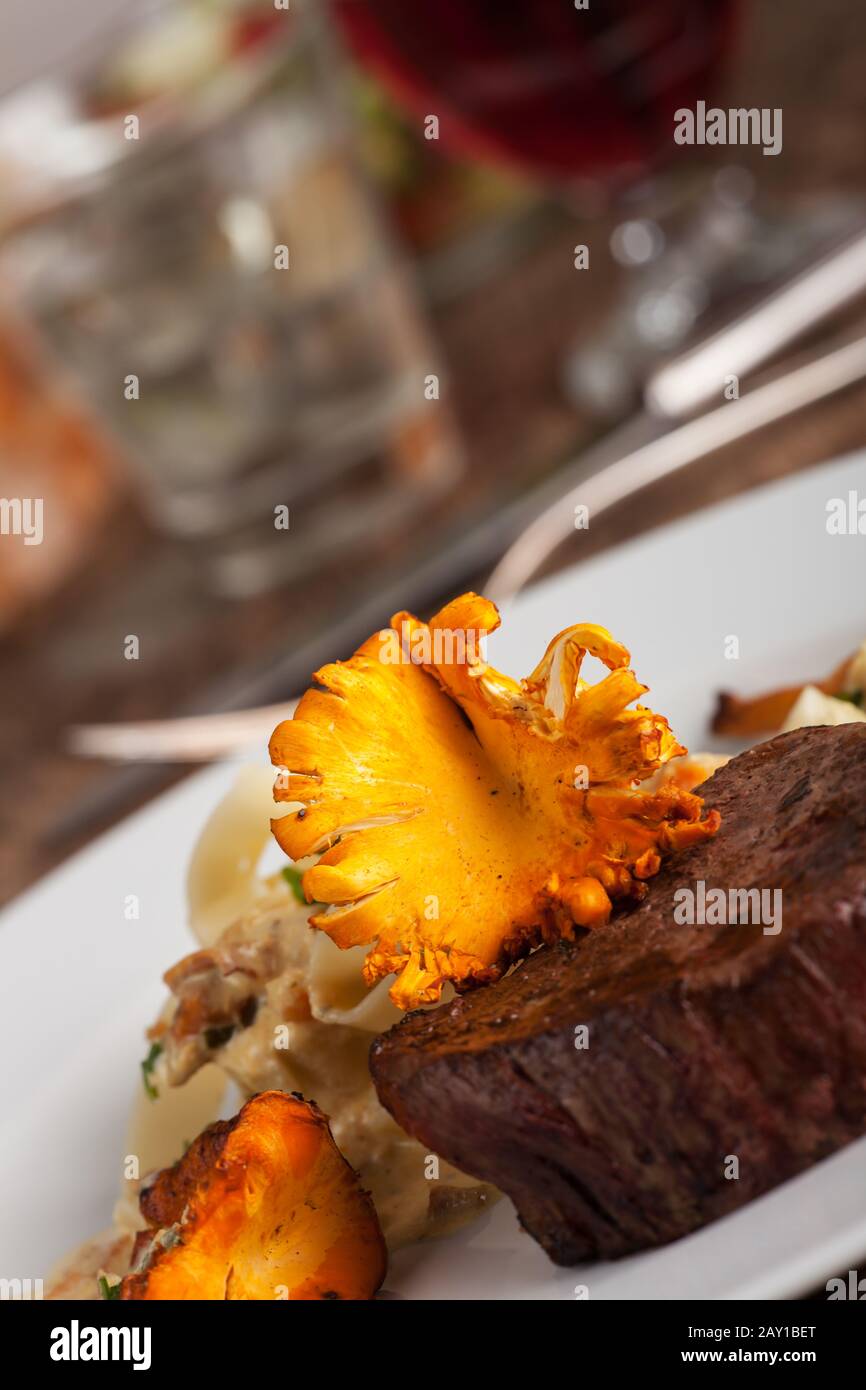 Steak with chanterelles and noodles Stock Photo Alamy