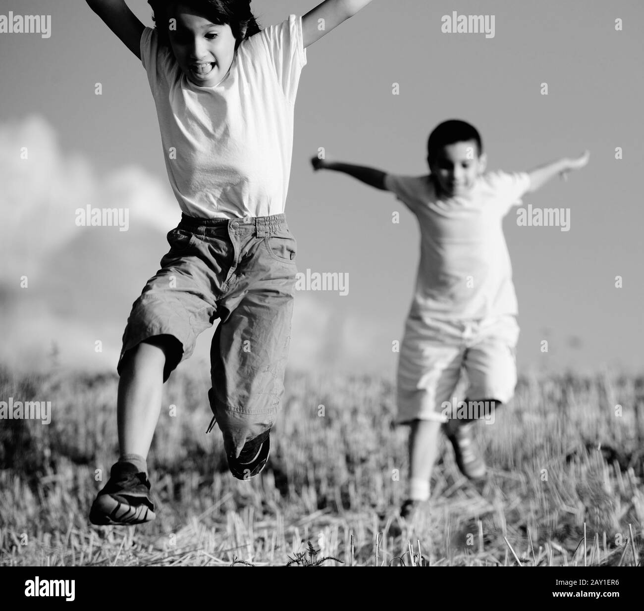 Two little boys on field running Stock Photo Alamy