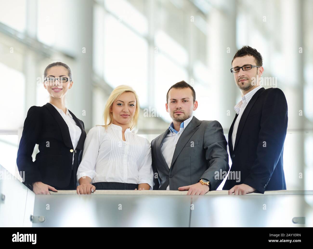 People Standing Behind Railing Successful business people standing on railing Stock Photo - Alamy