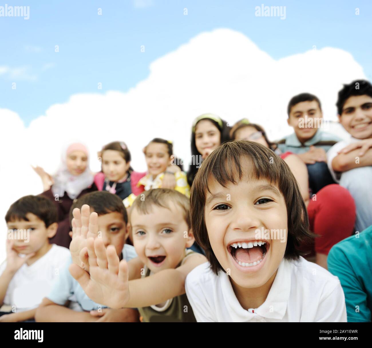 Crowd of children, different ages and races in front of the school, breaktime Stock Photo