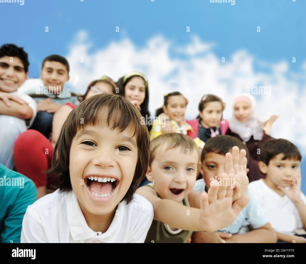Crowd of children, different ages and races in front of the school, breaktime Stock Photo