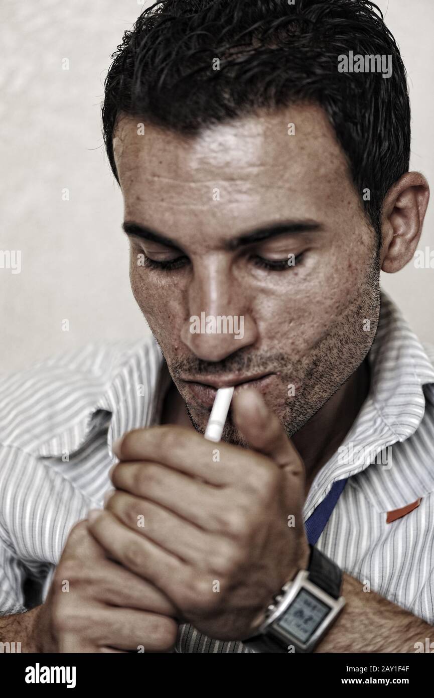 Middle aged man smoking cigarettes hi-res stock photography and images