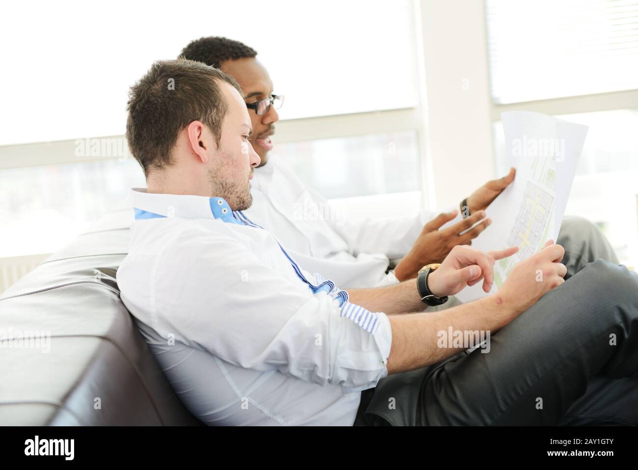 Group of multi ethnic business people at work discussing a project Stock Photo