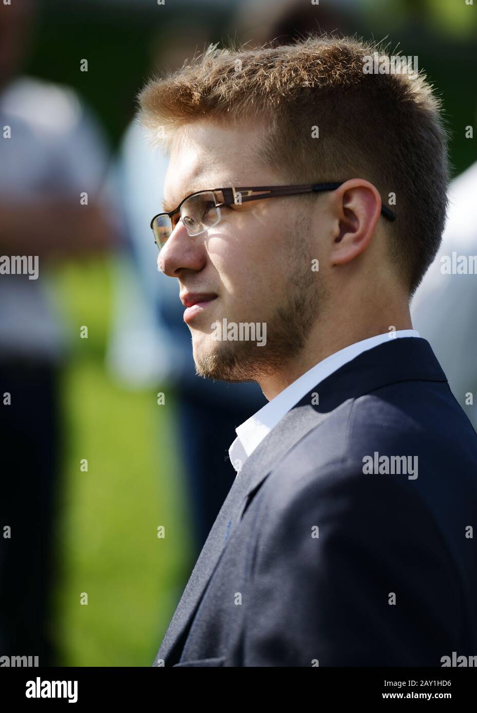 Young man wearing suit in nature Stock Photo - Alamy
