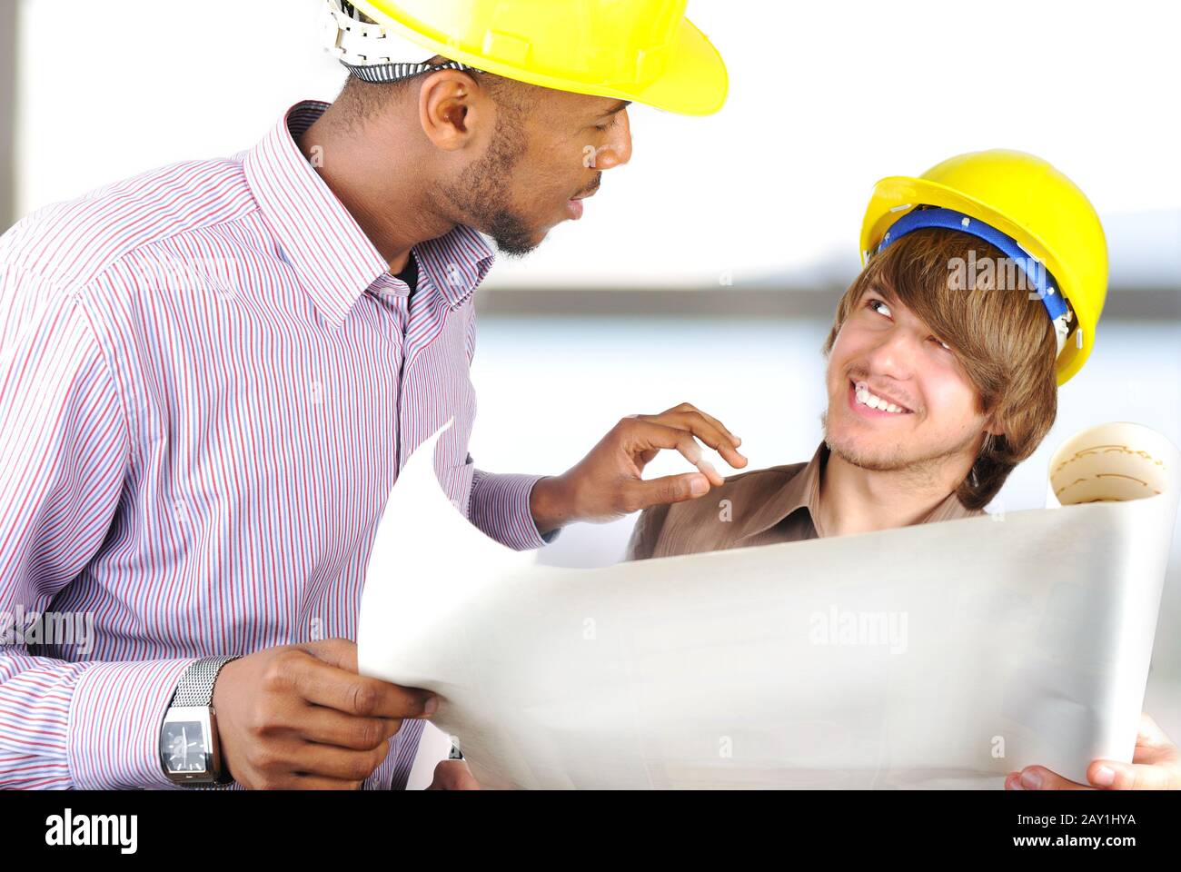Young engineers in office talking Stock Photo