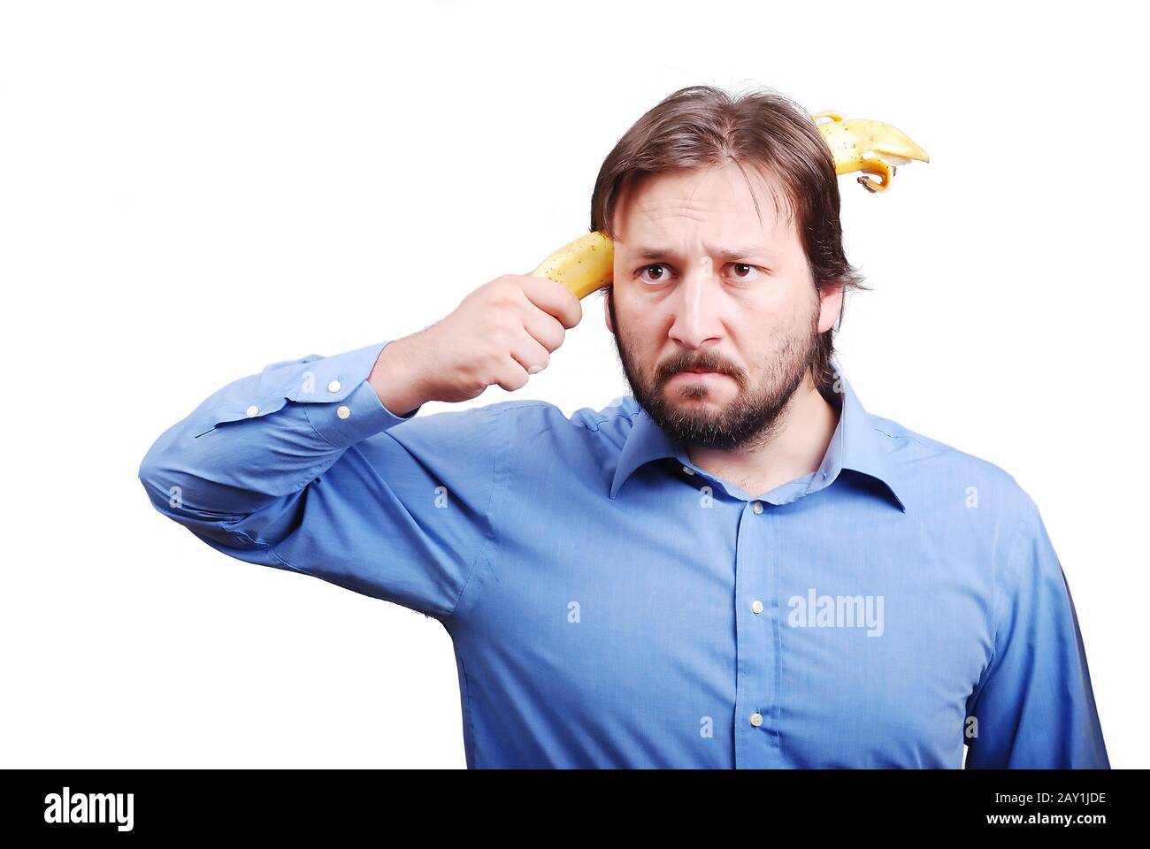 Young man blowing up his brain with banana Stock Photo Alamy