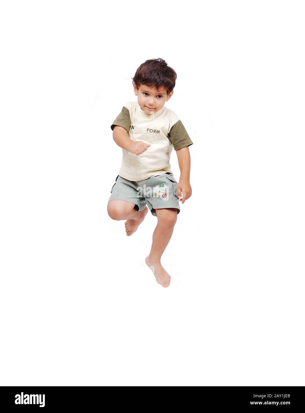 Happy little child in white clothes is jumping isolated Stock Photo - Alamy