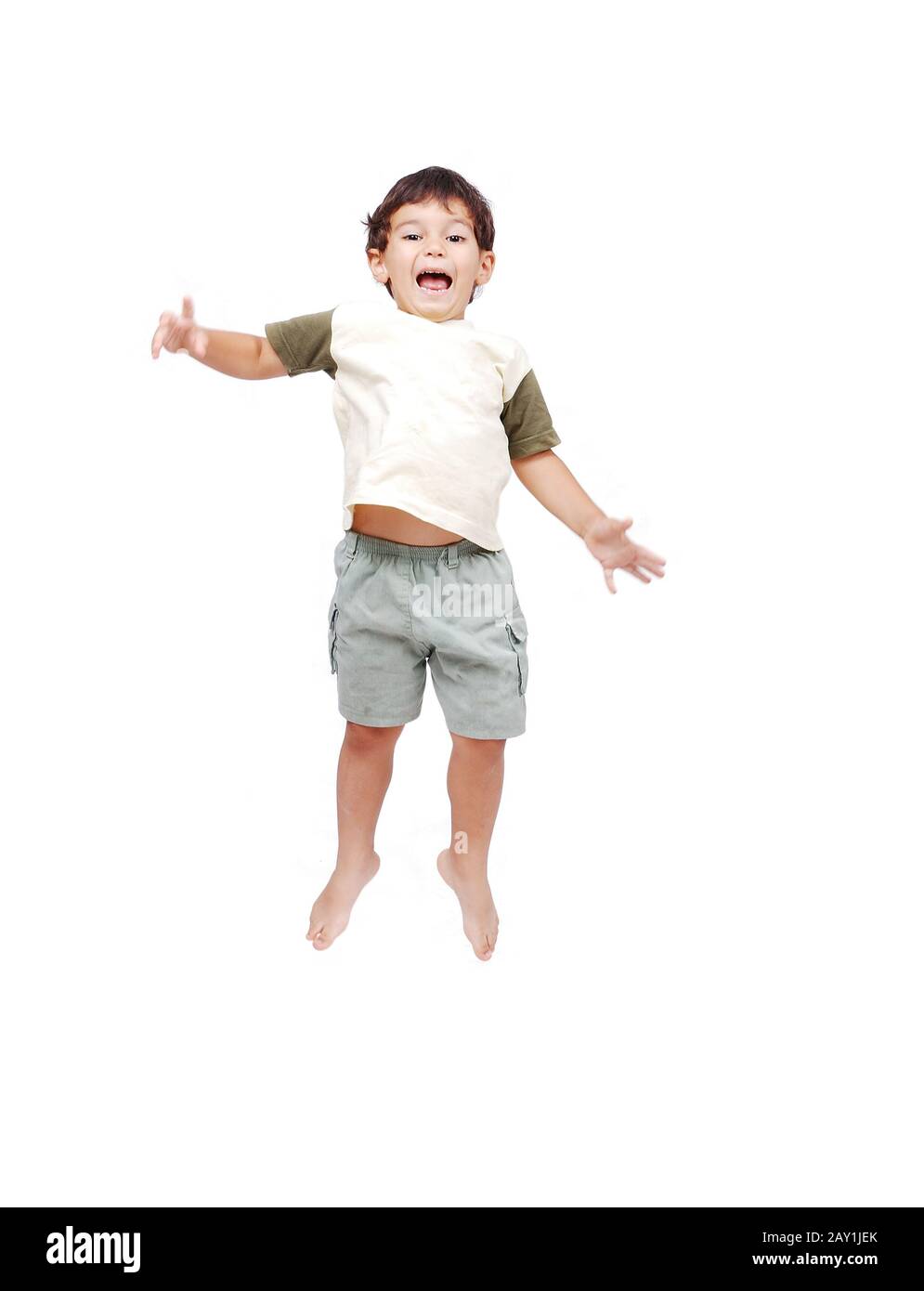 Happy little child in white clothes is jumping isolated Stock Photo - Alamy