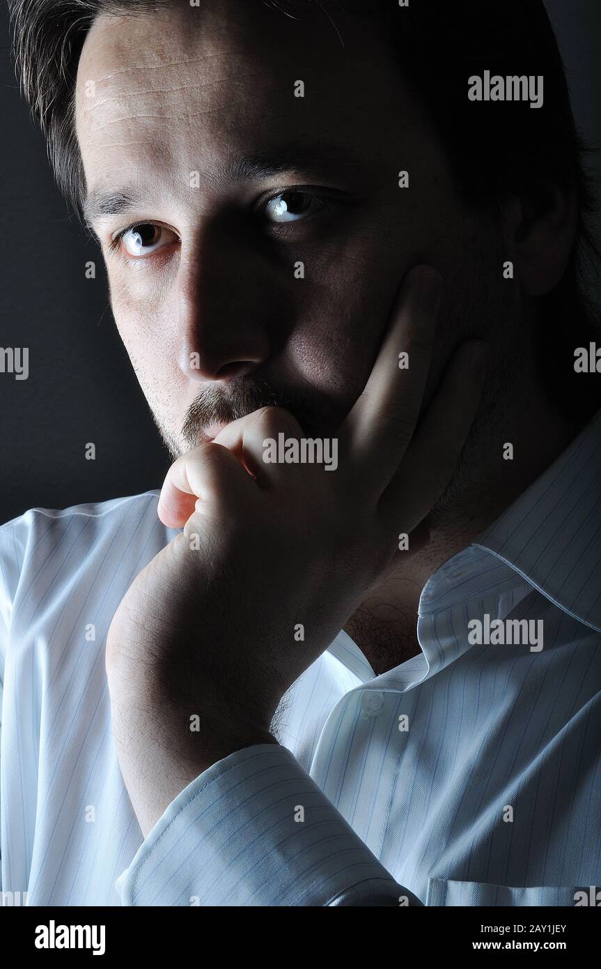 Young man smiling in the dark Stock Photo