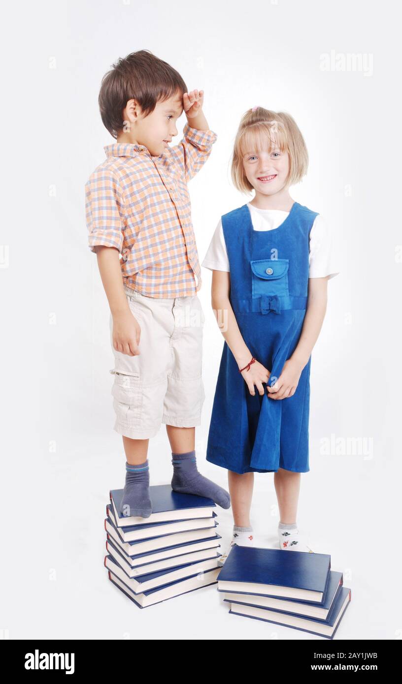 Little cute girl and boy with many books isolated Stock Photo - Alamy