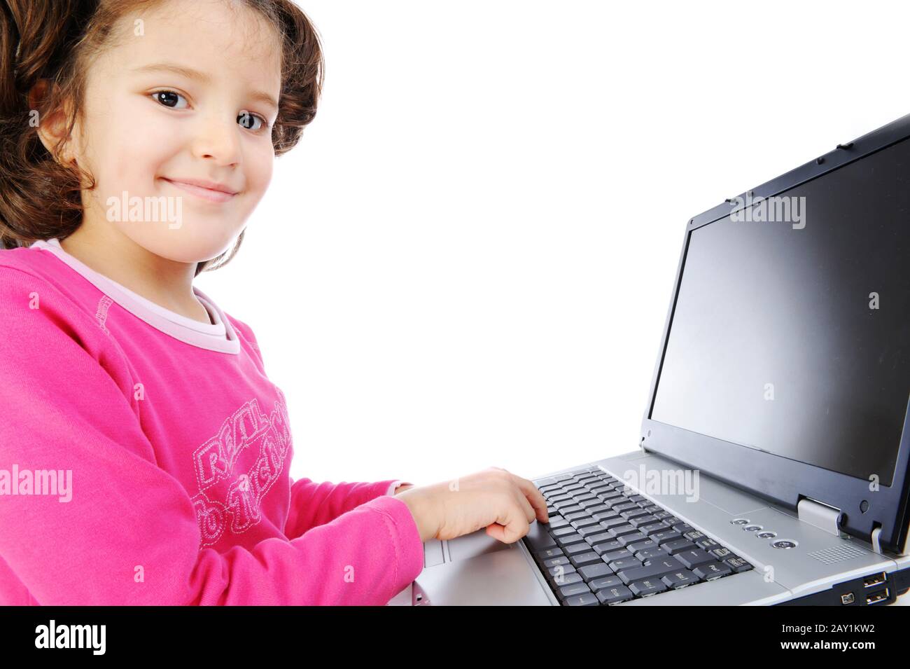 Beautiful little girl isolated with laptop Stock Photo - Alamy