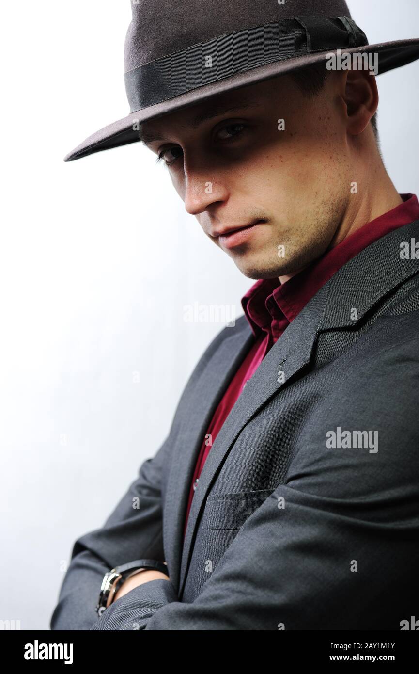 Elegant young man with a hat looking at camera Stock Photo