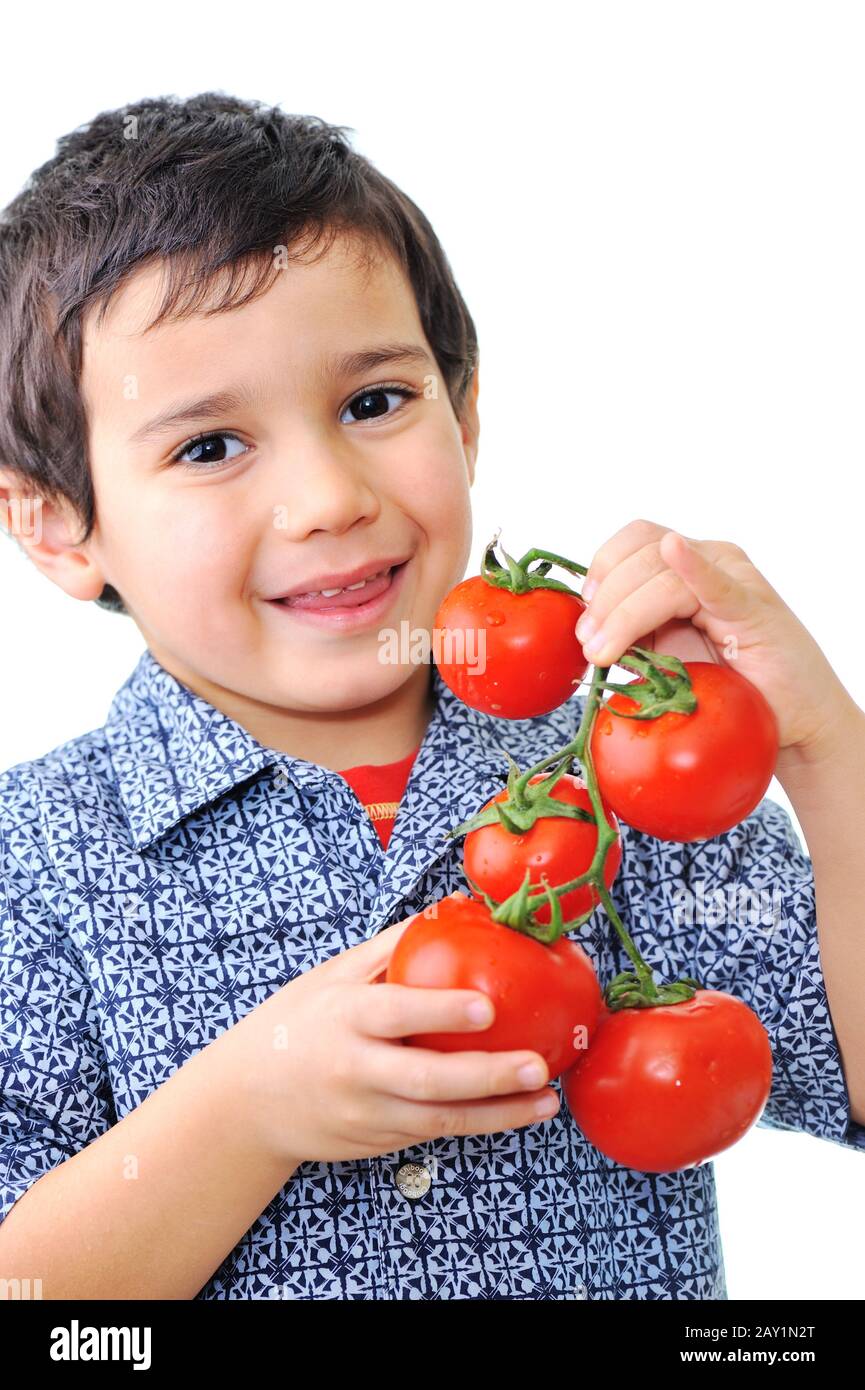 Handsome little boy holding tomatoes Stock Photo - Alamy