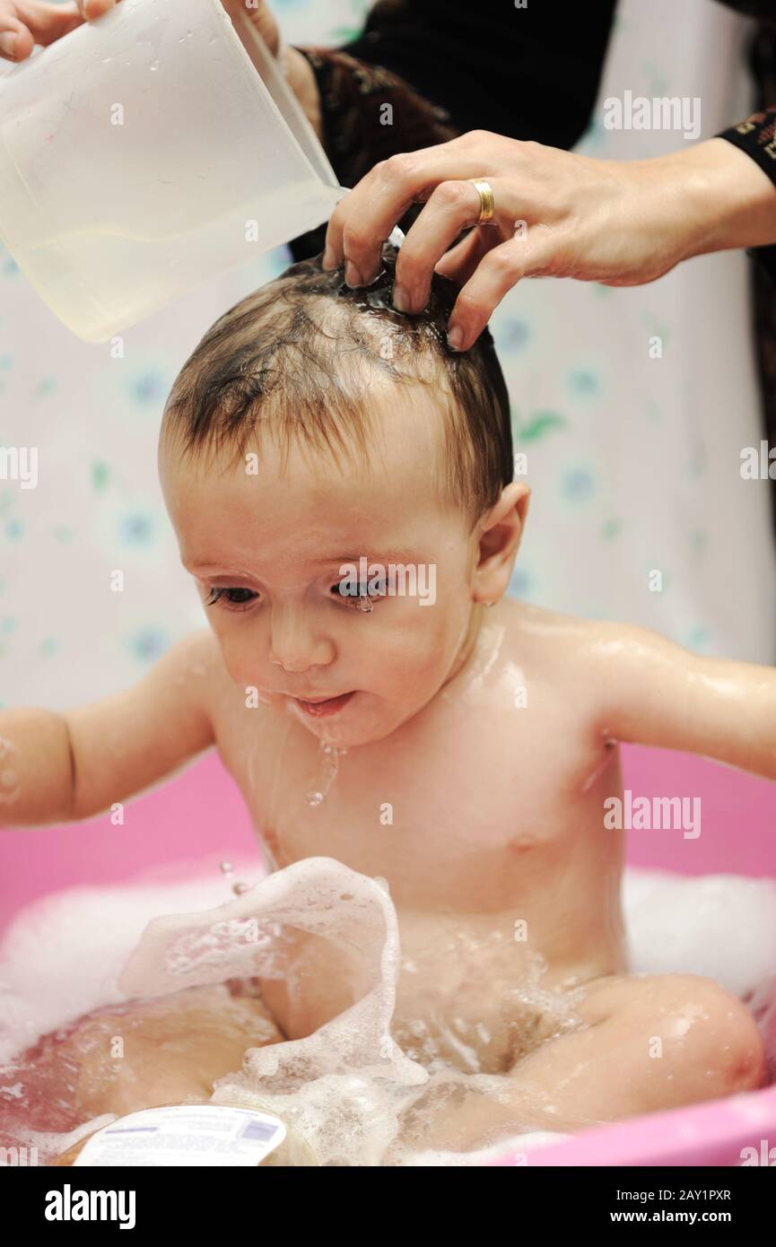 Adorable baby boy taking a bath with soap suds on hair Stock Photo Alamy